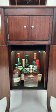 Load image into Gallery viewer, 1920&#39;s Victrola stand-up phonograph frontal view, liquor chamber doors open and displaying lighted liquor bottle collection.

