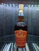 Load image into Gallery viewer, Open door view of whiskey barrel displaying customer's Bottle of Weller's Single Barrel Bourbon. Illuminated by white light and showing record albums below round glass shelf.