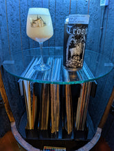 Load image into Gallery viewer, Open door view of whiskey barrel displaying customer's glass and can of Troon beer. Illuminated by blue hue light and showing record albums below round glass shelf.
