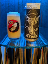 Load image into Gallery viewer, Open door view of whiskey barrel displaying customer's glass and can of Troon beer. Illuminated by blue hue light and showing record albums below round glass shelf.