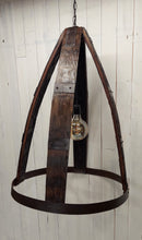Load image into Gallery viewer, Whiskey Barrel Chandelier with oversized Edison Bulb Constructed with four barrel staves, joined at the top by 4-way crossed barrel ring metal; secured at the bottom by full barrel ring 2-ring barrel ring accents evenly distanced between top and bottom on all four staves Chandelier has a three foot hanging chain Dimensions : 33in H, 25in diameter. Light is not illuminated, and chandelier displays all four barrel staves.