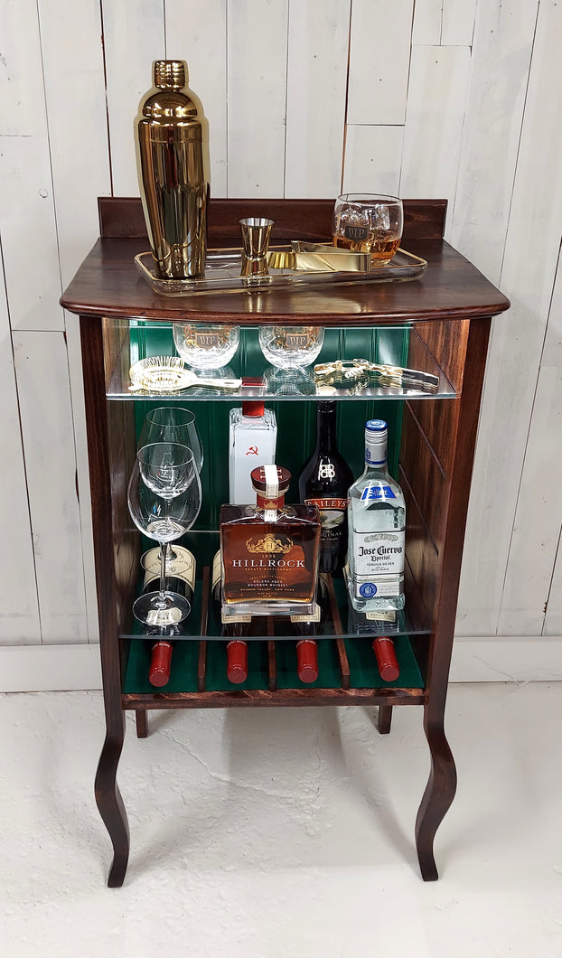 Larkin open-faced music cabinet with hunter green beadboard back panel.  Displays wine and liquor bottles and staged shaker and whiskey glass.