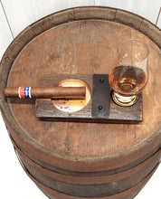 Load image into Gallery viewer, A top view of a cigar and whiskey glass, this genuine whiskey barrel stave, accented with a rustic barrel ring with a felt bottomed Glencairn Glass indent, and a copper bottomed cigar receptacle, measures 8” L x 4” W.
