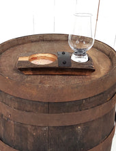 Load image into Gallery viewer, Frontal view of a genuine whiskey barrel stave, accented with a rustic barrel ring with a felt bottomed Glencairn Glass indent., and glass. Also with a copper bottomed cigar receptacle. Measures 8” L x 4” W.