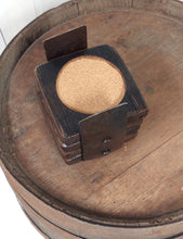 Load image into Gallery viewer, Top view of four whiskey barrel stave coasters in barrel ring holder.