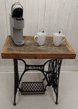 Load image into Gallery viewer, A barnboard tabletop affixed to a Singer sewing machine stand. Displays a Keurig coffee maker and two coffee cups.