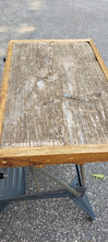 Load image into Gallery viewer, Side view of a barnboard tabletop affixed to a Singer sewing machine stand.